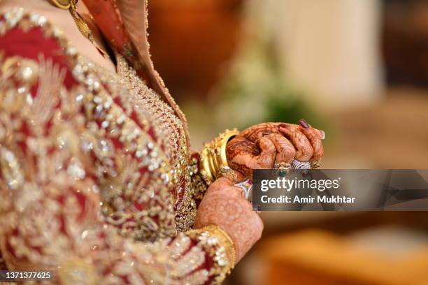 asian bride showing her jewelry in her arms and hands. - pakistani gold jewelry stock pictures, royalty-free photos & images