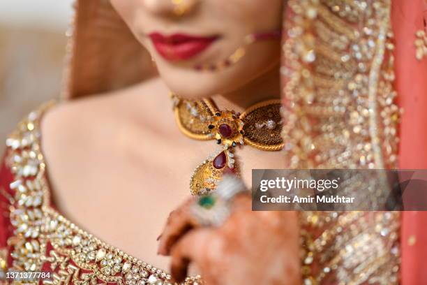 closeup of bride half face with necklace and wedding dress. - gold embroidery stock pictures, royalty-free photos & images