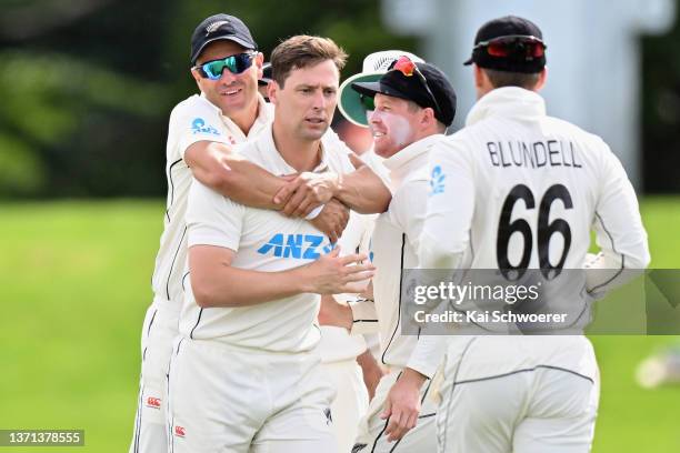 Matt Henry of New Zealand is congratulated by team mates after dismissing Rassie van der Dussen of South Africa during day three of the First Test...