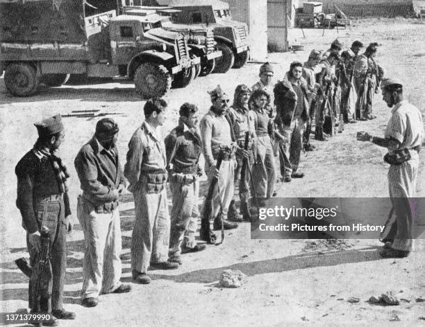 Soldiers of the Israeli Palmach receive orders before participating in 'Operation Yoav', Arab-Israeli War, 1948.