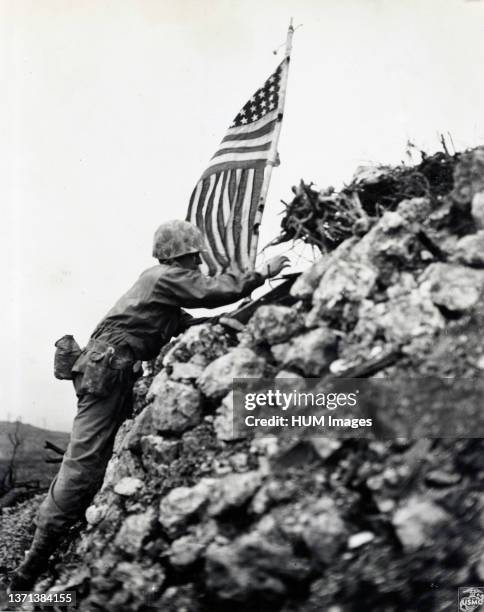 Marine Lt. Col. R.P. Ross Jr. Places Flag on one of the remaining ramparts of Shuri Castle on Okinawa.Same flag rasied by the first marine div at...