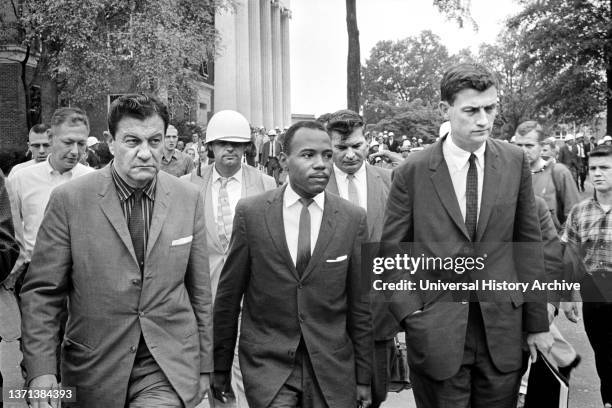 James Meredith, first African-American student admitted to University of Mississippi, walking to class accompanied by U.S. Marshals, Oxford,...