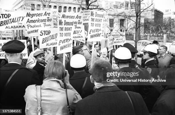 African American Demonstrators outside White House, with signs "We demand the right to vote, everywhere" and Signs Protesting Police Brutality...