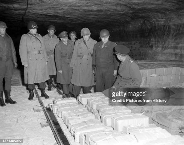 Gen. Dwight D. Eisenhower, Supreme Allied Commander, accompanied by Gen. Omar Bradley and other senior US officers, tours German salt mines in which...