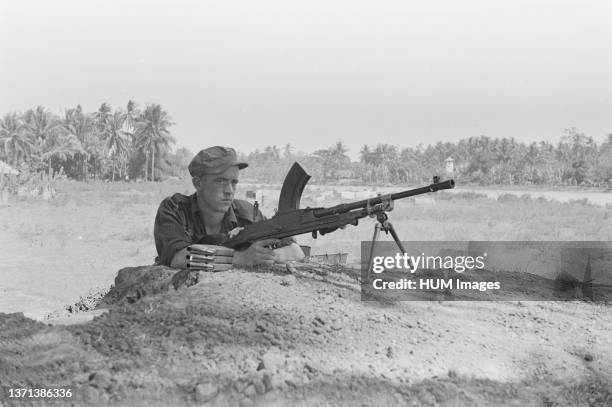 Soldier behind a dropout in Indonesia, Java, Dutch East Indies, Tjileungsir ca. 1946.