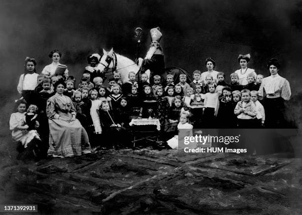 Sinterklaas and Zwarte Piet visiting an elementary school in Alkmaar Netherlands ca. 1908 / Santa Claus and his black faced assistant Black Pete...