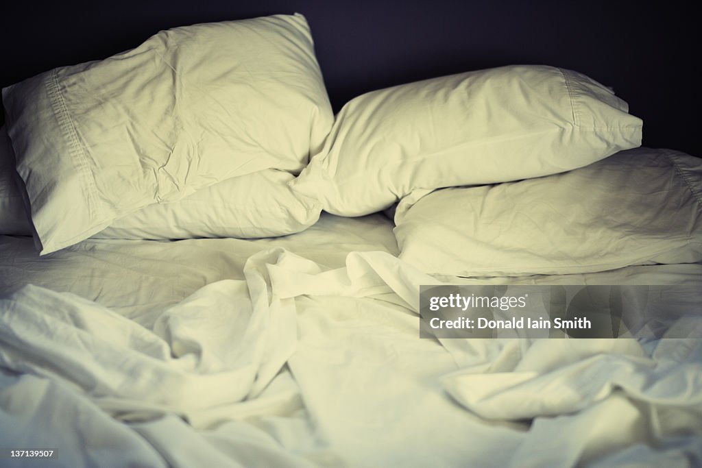 Bed with white cotton sheets