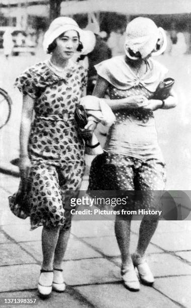 Two 'moga' or 'modern girls' on the streets of Tokyo, c. 1928.