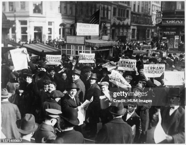 Peace rumor, New York. Crowd at Times Square holding up Extras telling about the signing of the Armistice. The Government report that the news was...