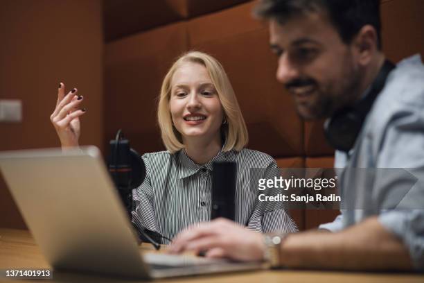 attractive young female cohosting a radio show with male colleague - television interview stock pictures, royalty-free photos & images