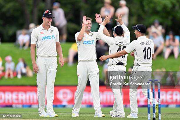 Tim Southee of New Zealand is congratulated by team mates after dismissing Glenton Stuurman of South Africa during day three of the First Test Match...