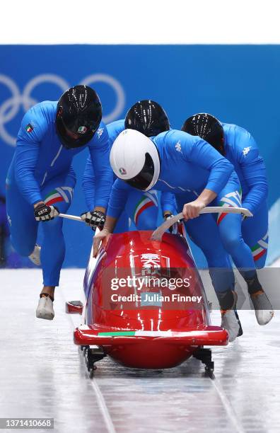 Patrick Baumgartner, Eric Fantazzini, Alex Verginer and Lorenzo Bilotti of Team Italy slide during the four-man Bobsleigh heats on day 15 of Beijing...