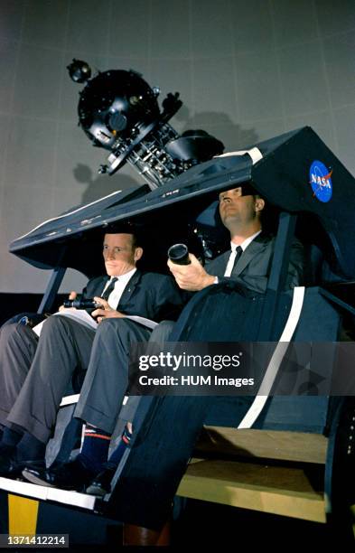 Astronauts James A. McDivitt and Edward H. White II are shown at the Morehead Planetarium in North Carolina, checking out celestial navigation...