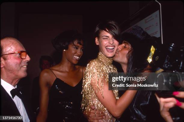 Linda Evangelista is kissed by photographer Steven Meisel as Francesco Scavullo and Naomi Campbell look on at the CFDA Fashion Awards in New York...