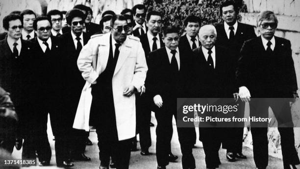 Group of Yakuza gangsters sporting business suits and emanating menace, possibly members of the Tokyo-Yokohama based Inagawa-Kai, c. 1960.