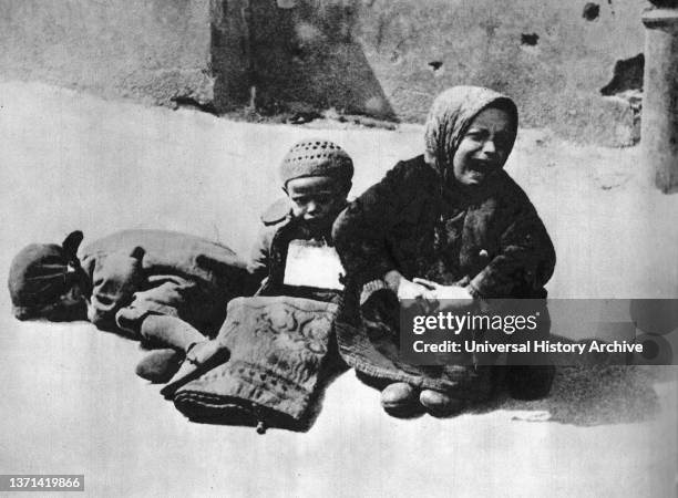 Starving Jewish children sit in despair on a street in the Warsaw Ghetto, Poland 1941. The Ghetto was the largest of all the Nazi ghettos during...