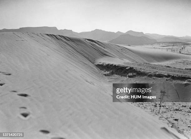 Middle East History - Agriculture in Egypt. Road blockaded with sand dunes compelling cars to find a circuitous course around the dunes to reach the...