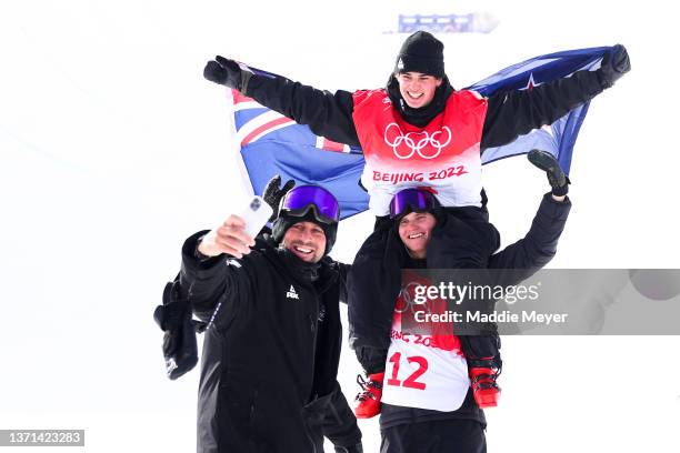 Gold medallist Nico Porteous of Team New Zealand celebrates with teammate and brother Miguel Porteous and a team member during the Men's Freestyle...