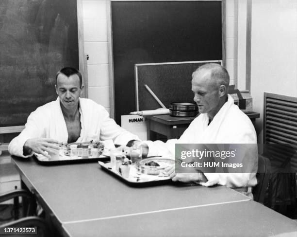 Astronauts Alan Shepard and John Glenn at breakfast before Shepard's Mercury-Redstone 3 spaceflight.