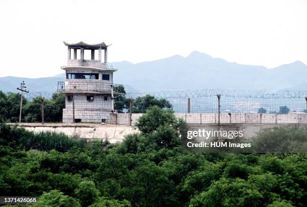 View of the concrete wall and barbed wire separating South Korea from North Korea Kijong-Dong 'Propaganda Village'. Note the Communist red star...