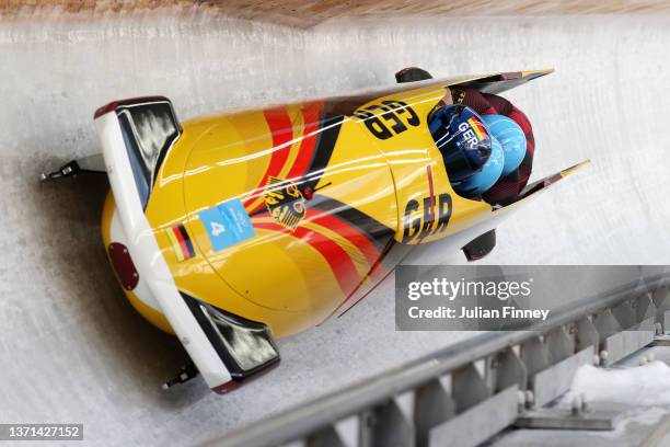 Francesco Friedrich, Thorsten Margis, Candy Bauer and Alexander Schueller of Team Germany slide during the four-man Bobsleigh heats on day 15 of...