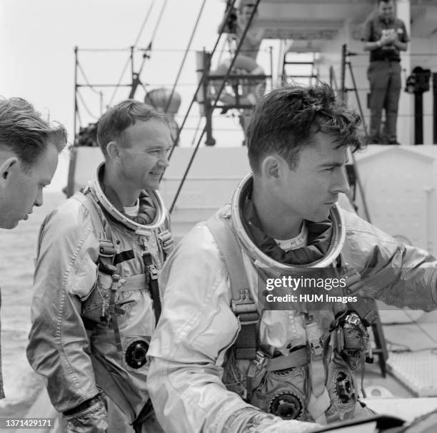 Gemini-10 prime crew members, astronaut Michael Collins , pilot, and John W. Young, command pilot, onboard the NASA Motor Retriever during water...