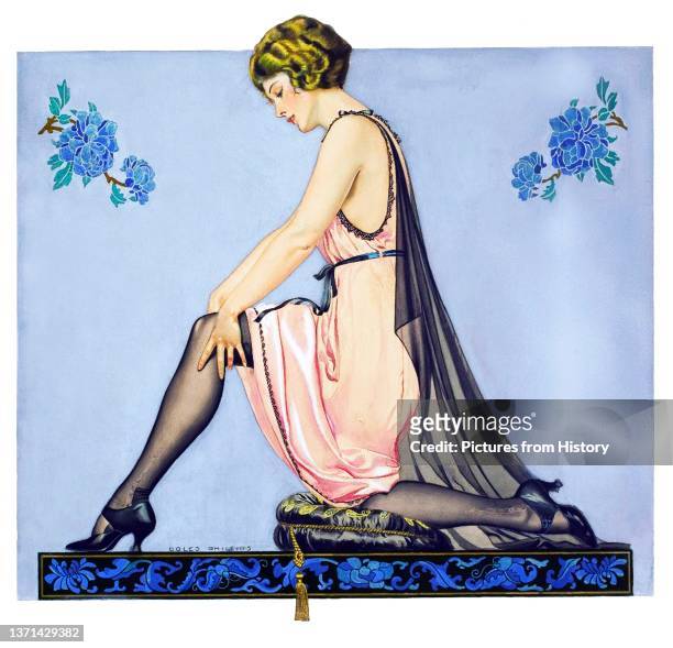 Kneeling woman in slip, black lace cape, and black high-heeled shoes adjusts her stocking. Advertising poster for Holeproof Hosiery Company, Clarence...