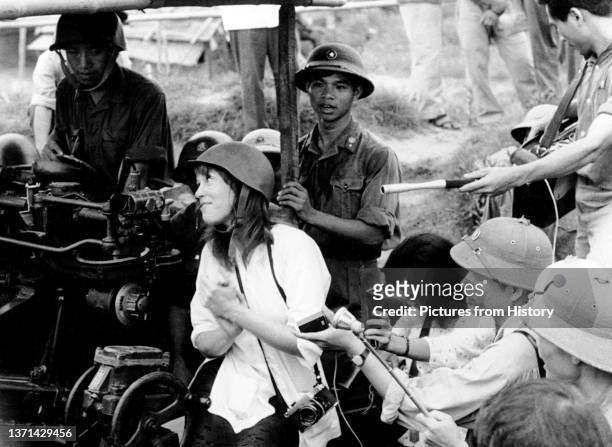Jane Fonda talking with a North Vietnamese anti-aircraft gun crew, Hanoi, July 1972.