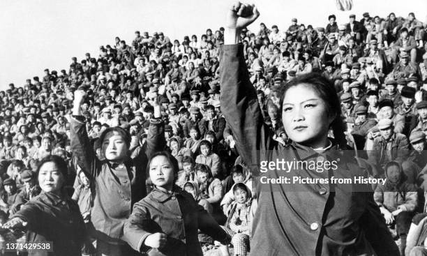 Enthusiastic 'Red Guards' wave copies of Mao Zedong's 'Little Red Book' , c. 1966.