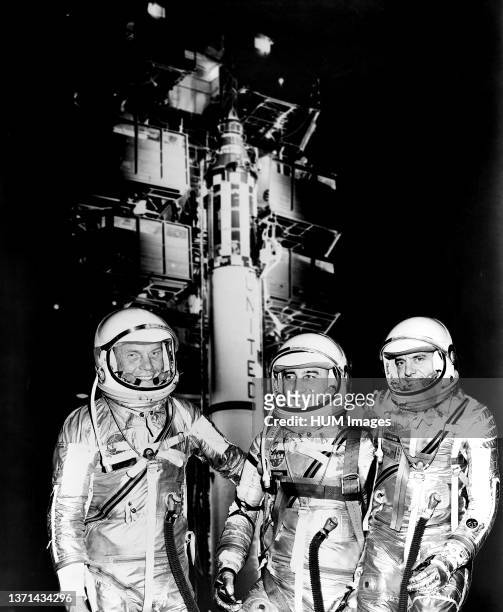 Mercury astronauts John H. Glenn Jr., Virgil I. Grissom and Alan B. Shepard Jr. Standing by Redstone rocket in their spacesuits.