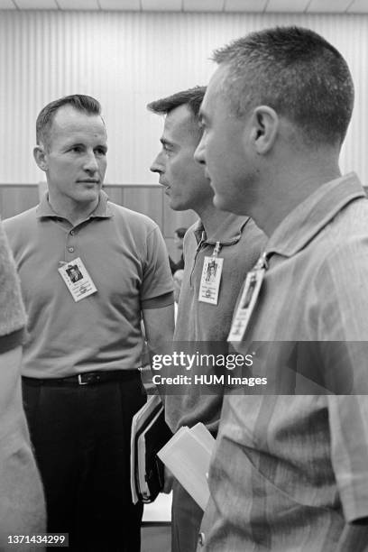 The prime crew of the NASA Gemini-Titan 3 mission, astronauts John W. Young , pilot; and Virgil I. Grissom , command pilot, hold a discussion at the...