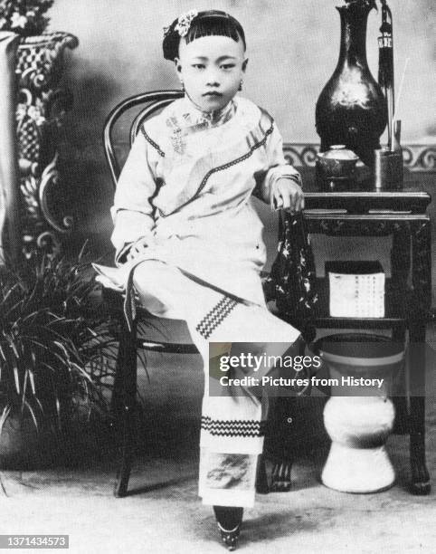 Young Han Chinese girl from a wealthy family with bound feet, late 19th-early 20th century.