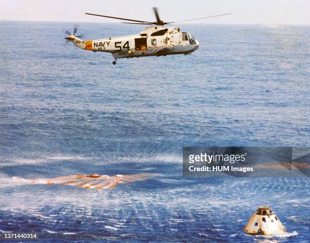 Immediately after splashdown a recovery helicopter from the USS Guadalcanal hovers over the Apollo 9 spacecraft.
