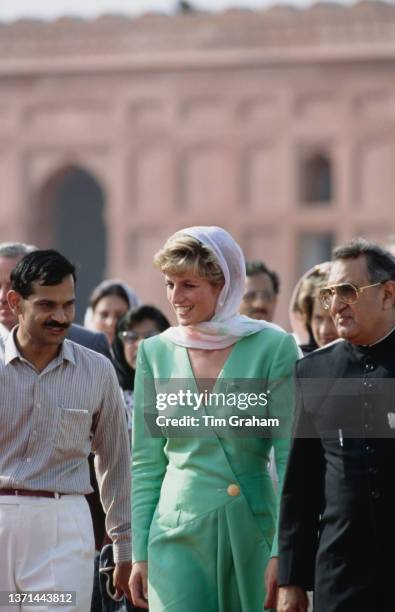 British Royal Diana, Princess of Wales , wearing a green Catherine Walker dress, her head covered with a white shawl as she visits the Badshahi...