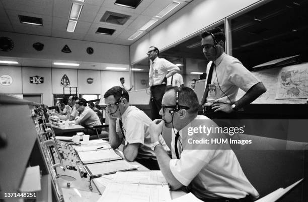 View of activity at the flight director's console in the Mission Operations Control Room in the Mission Control Center, Building 30, on the first day...