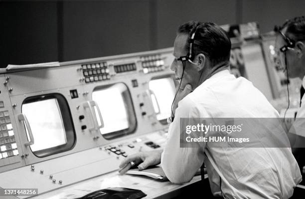 Astronaut M. Scott Carpenter monitors the Booster Systems Console in the Manned Spacecraft Center Mission Control Center during launch of the...