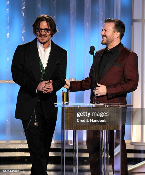 In this handout photo provided by NBC, actor Johnny Depp and host Ricky Gervais talk onstage during the 69th Annual Golden Globe Awards at the...