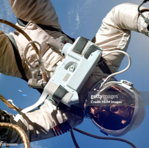 Astronaut Edward H. White II, pilot of the Gemini IV four-day Earth-orbital mission, floats in the zero gravity of space outside the Gemini IV...