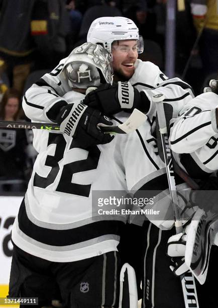 Adrian Kempe of the Los Angeles Kings hugs teammate Jonathan Quick as they celebrate on the ice after Kempe scored a goal in overtime to defeat the...