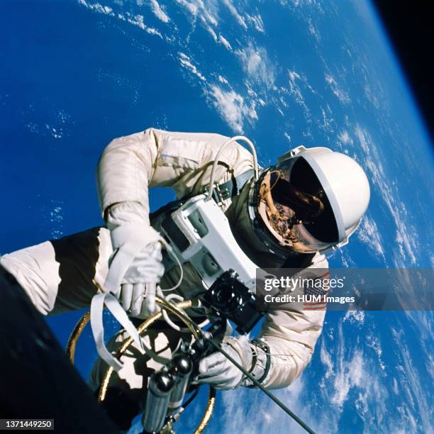 June 1965) Astronaut Edward H. White II, pilot of the Gemini IV four-day Earth-orbital mission, floats in the zero gravity of space outside the...