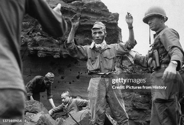 Japanese troops surrendering to US Marines, Iwo Jima, April 1945.