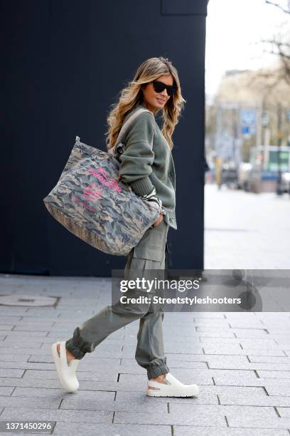 Influencer Gitta Banko wearing a black and white zebra animal print shirt by Sem Per Lei, an olive green cardigan by Sem Per Lei, olive green cargo...