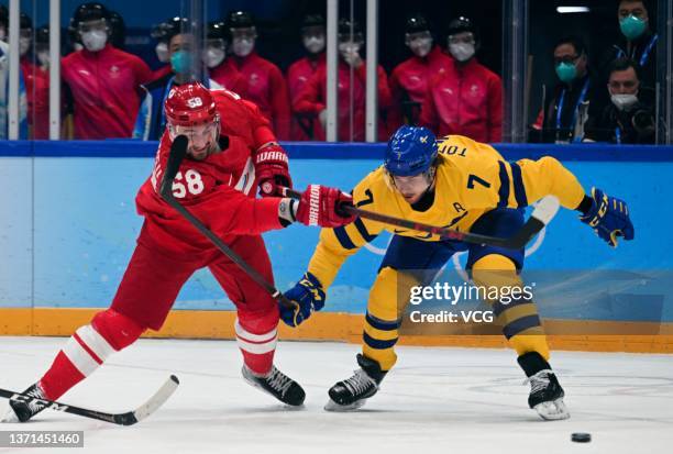 Anton Slepyshev of Team ROC and Henrik Tommernes of Team Sweden compete during the Men's Ice Hockey Playoff Semifinal match between Team ROC and Team...