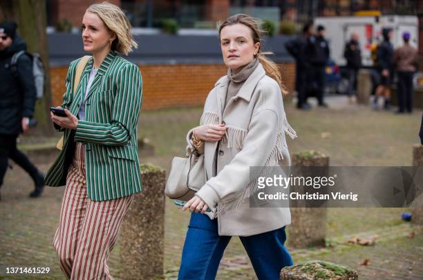 Guest is seen wearing striped blazer & pants and a guest wearing creme white jacket with fringes, denim jeans outside Bora Aksu during London Fashion...