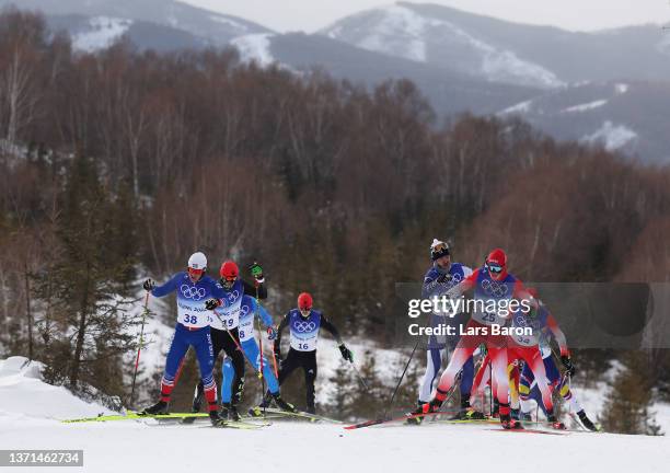 Snorri Eythor Einarsson of Team Iceland and Jason Rueesch of Team Switzerland compete during the Men's Cross-Country Skiing 50km Mass Start Free on...