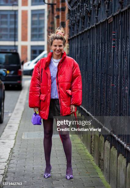 Mija Knezevic seen wearing red jacket, skirt, sheer tights, purple bag outside Bora Aksu during London Fashion Week February 2022 on February 18,...