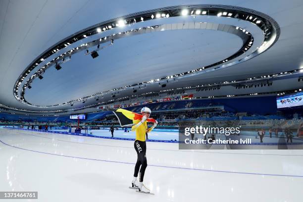 Bart Swings of Team Belgium celebrates winning the Gold medal during the Men's Mass Start Final on day fifteen of the Beijing 2022 Winter Olympic...