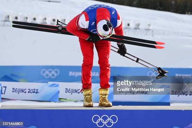 Gold medallist Alexander Bolshunov of Team ROC reacts during the Men's Cross-Country Skiing 50km Mass Start Free flower ceremony on Day 15 of the...