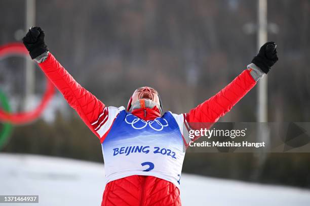 Gold medallist Alexander Bolshunov of Team ROC celebrates during the Men's Cross-Country Skiing 50km Mass Start Free flower ceremony on Day 15 of the...