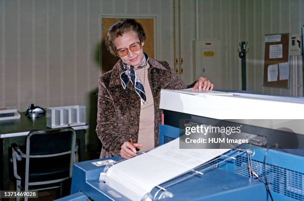 Mrs. Katherine G. Johnson at Work looking at a computer printout at Langley Research Center